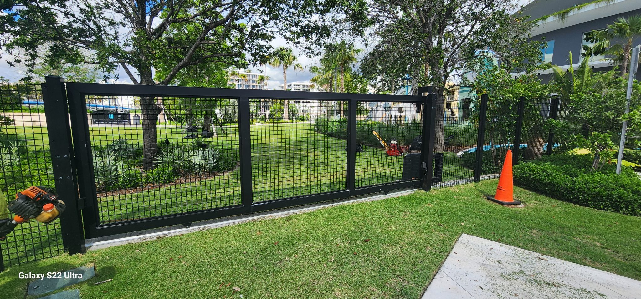 Completed black mesh fence and sliding access gate